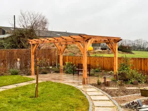 A stunning oak frame pergola with staddle stones