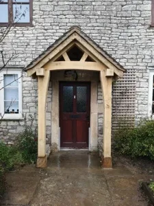 An oak framed porch sitting on staddle stones